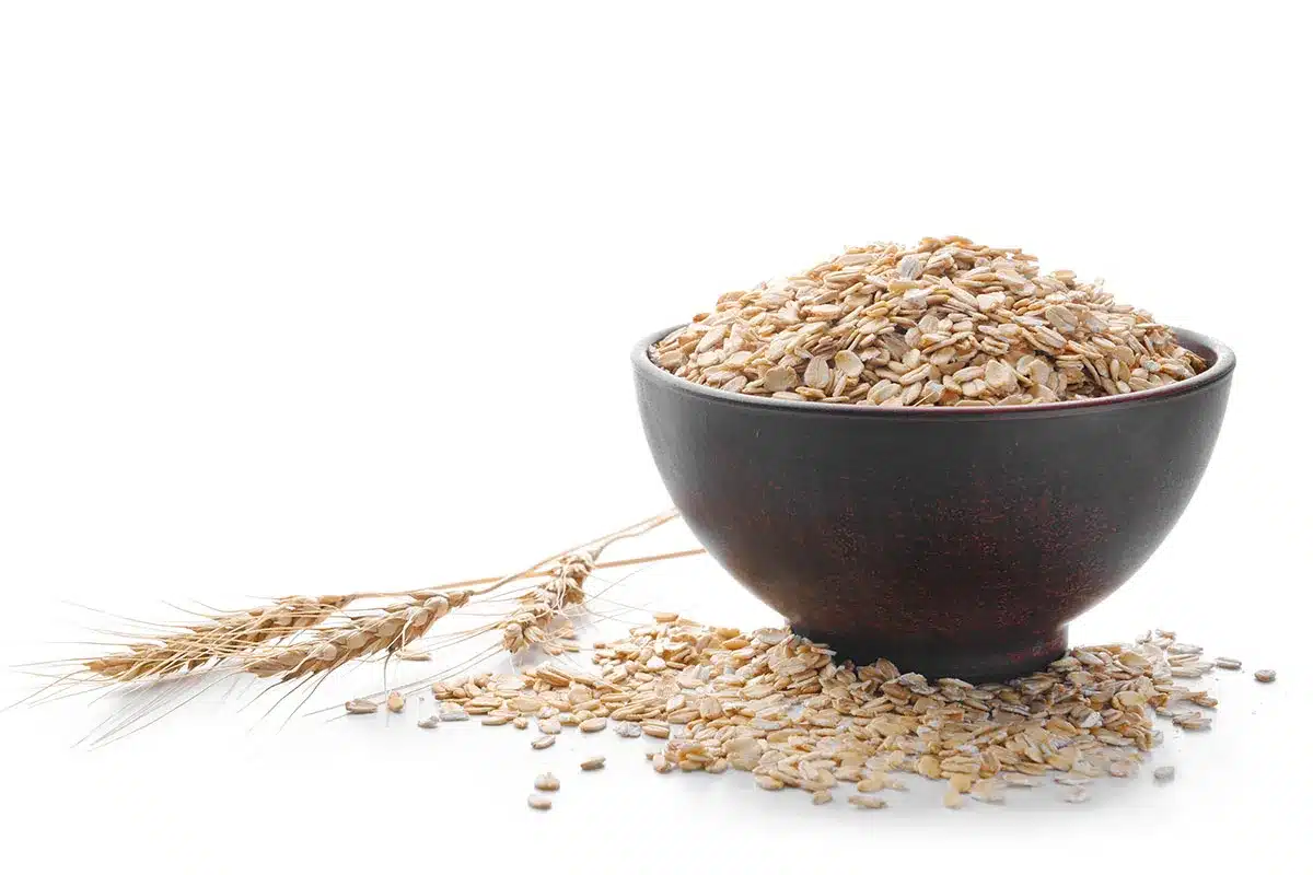 Bowl of oatmeal and wheat stalks.
