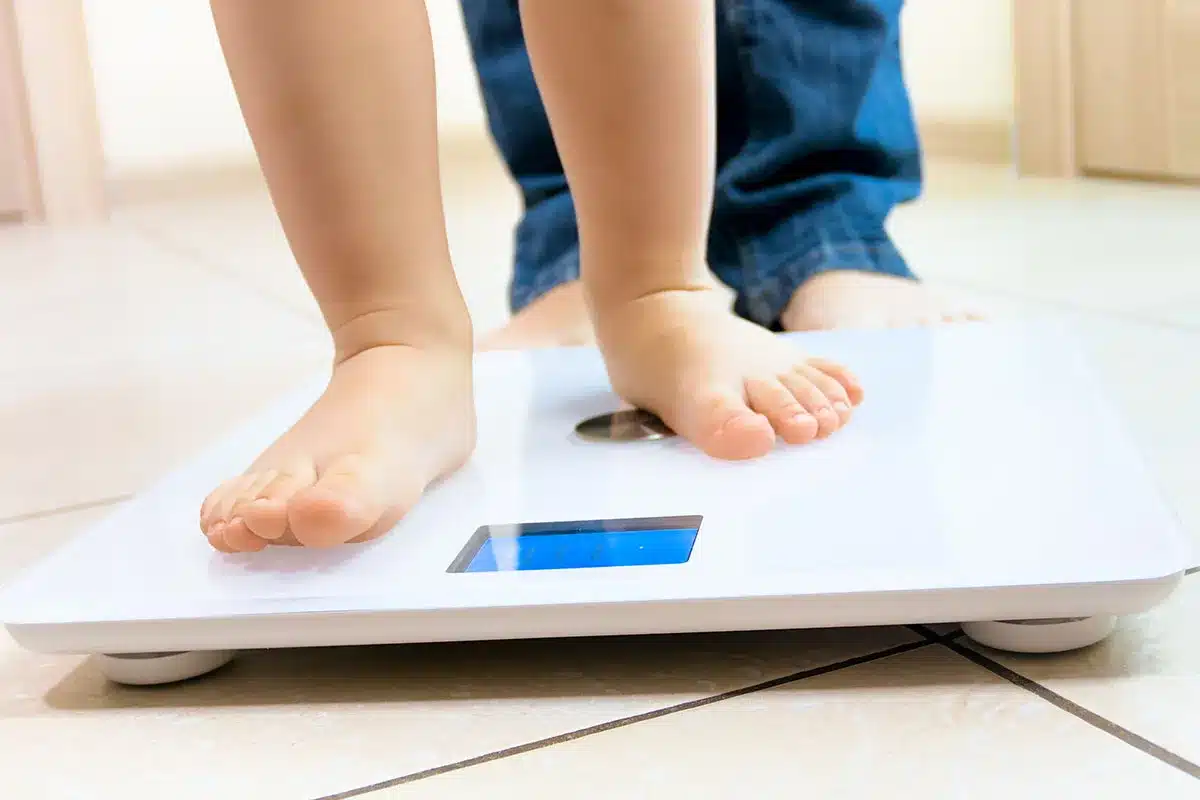 Child and adult on scales.