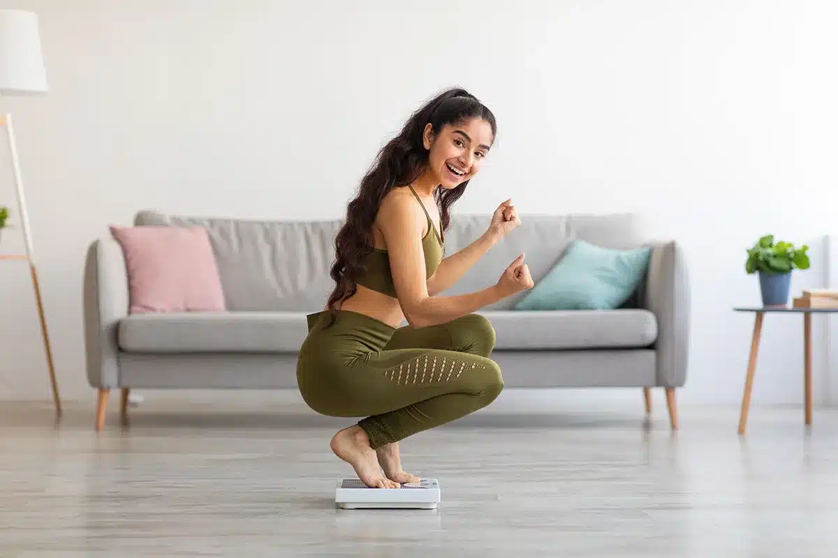 Happy woman celebrating weight loss.