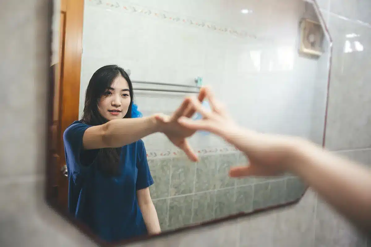 Woman looking in the mirror.