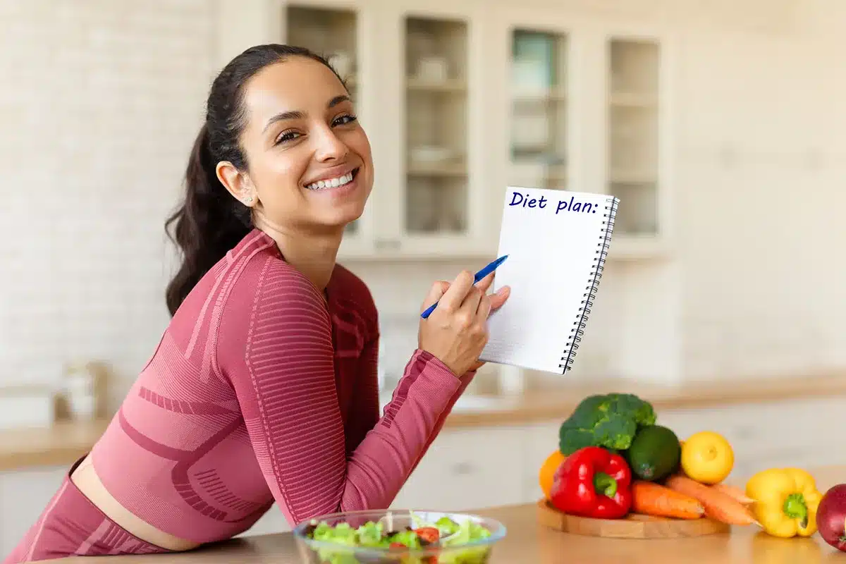 Woman writing diet plan.