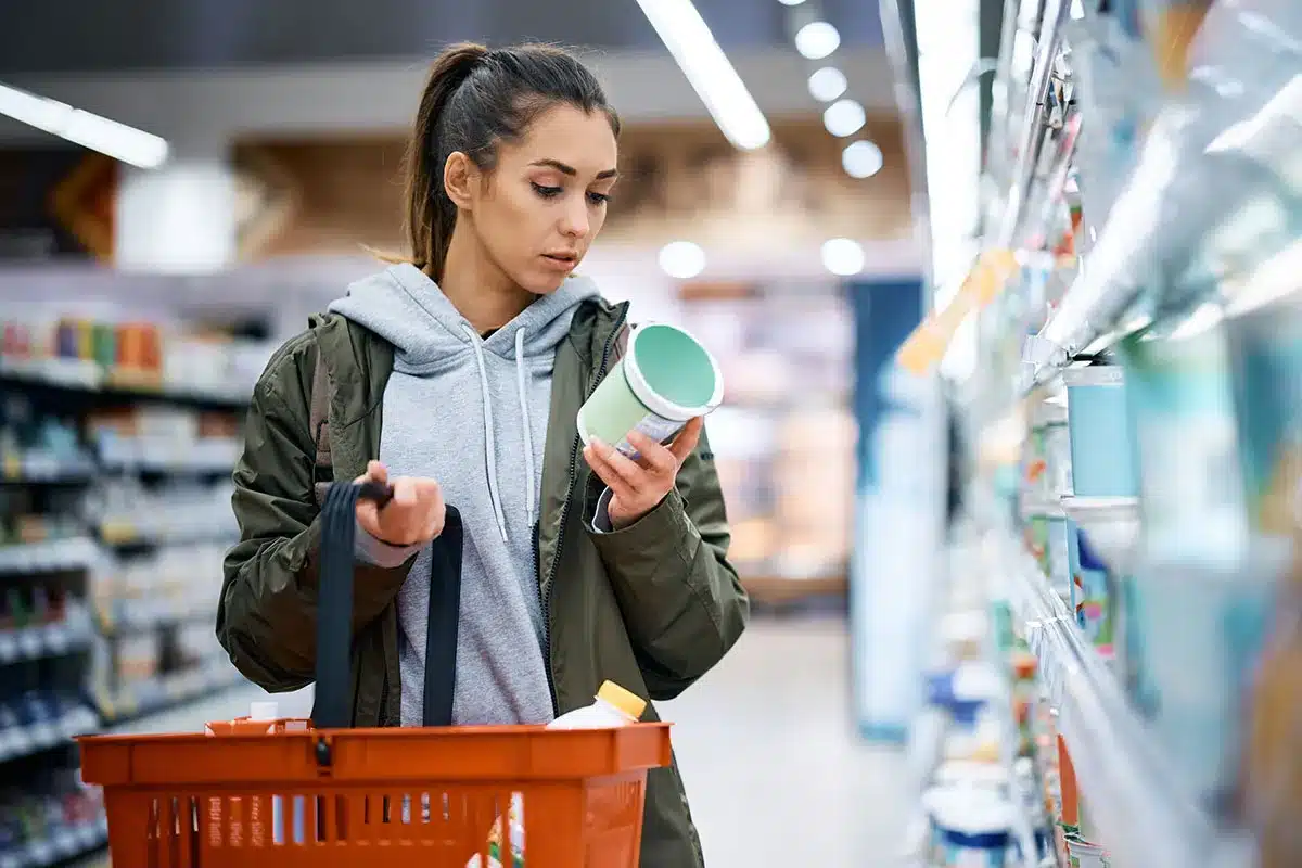 Woman reading food label.