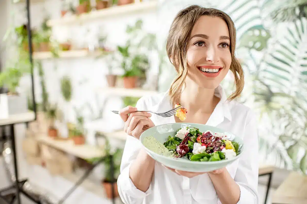 Woman eating healthy salad.