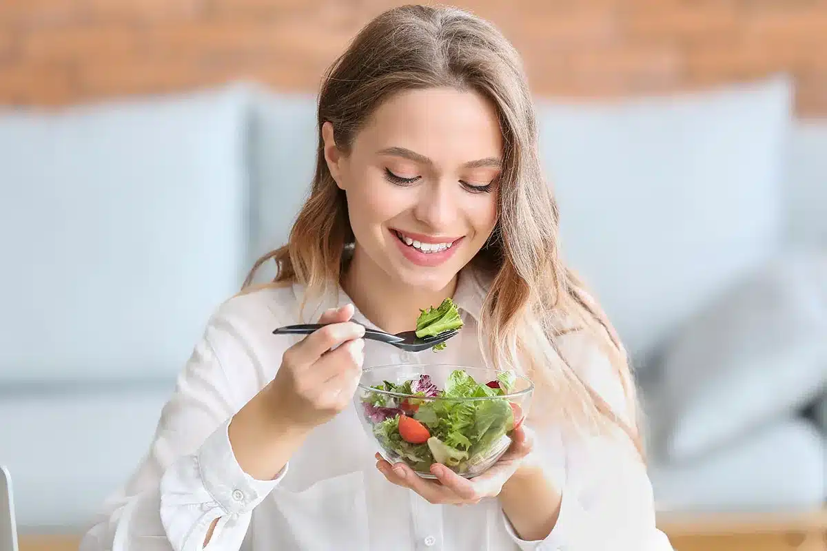 Woman eating a salad.
