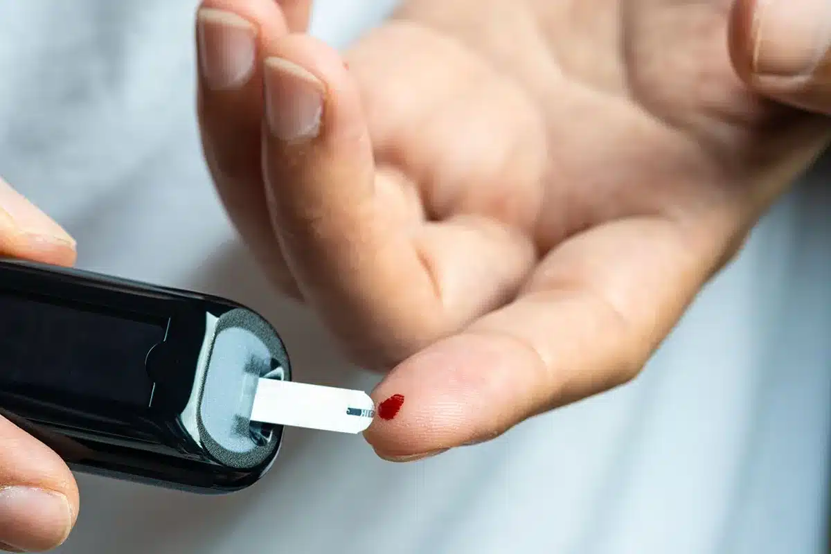 Person testing blood sugar.