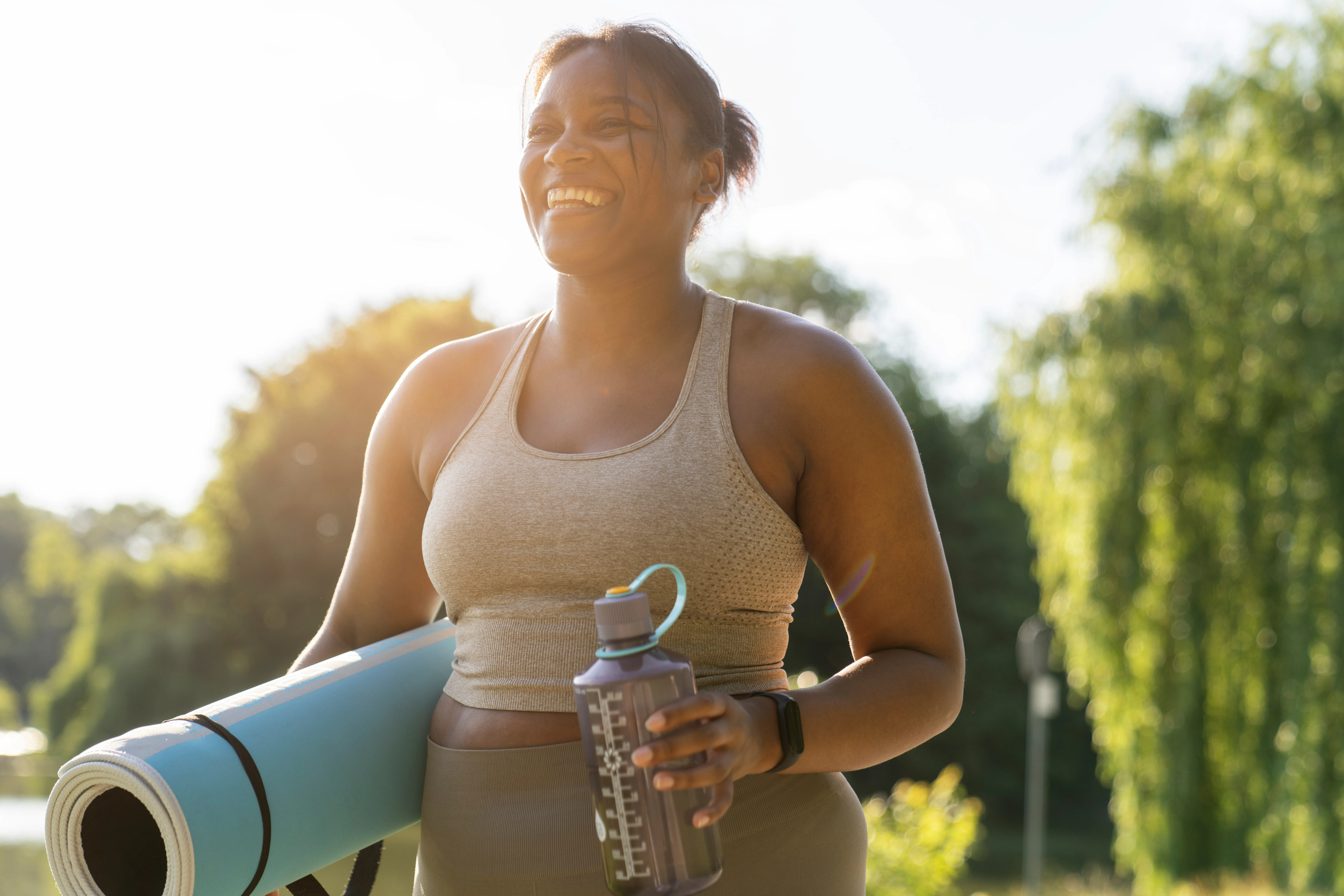 Plus-size woman carrying yoga mat.