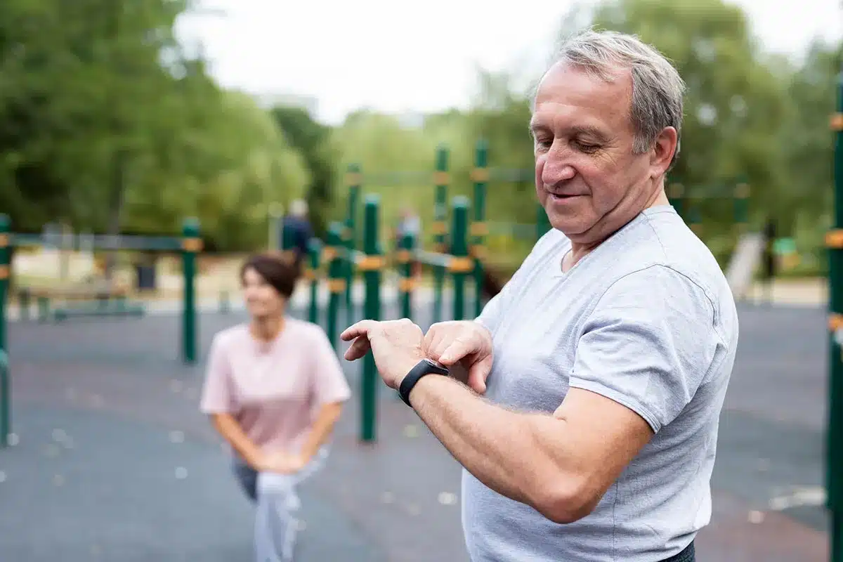 Senior man checking fitness tracker.