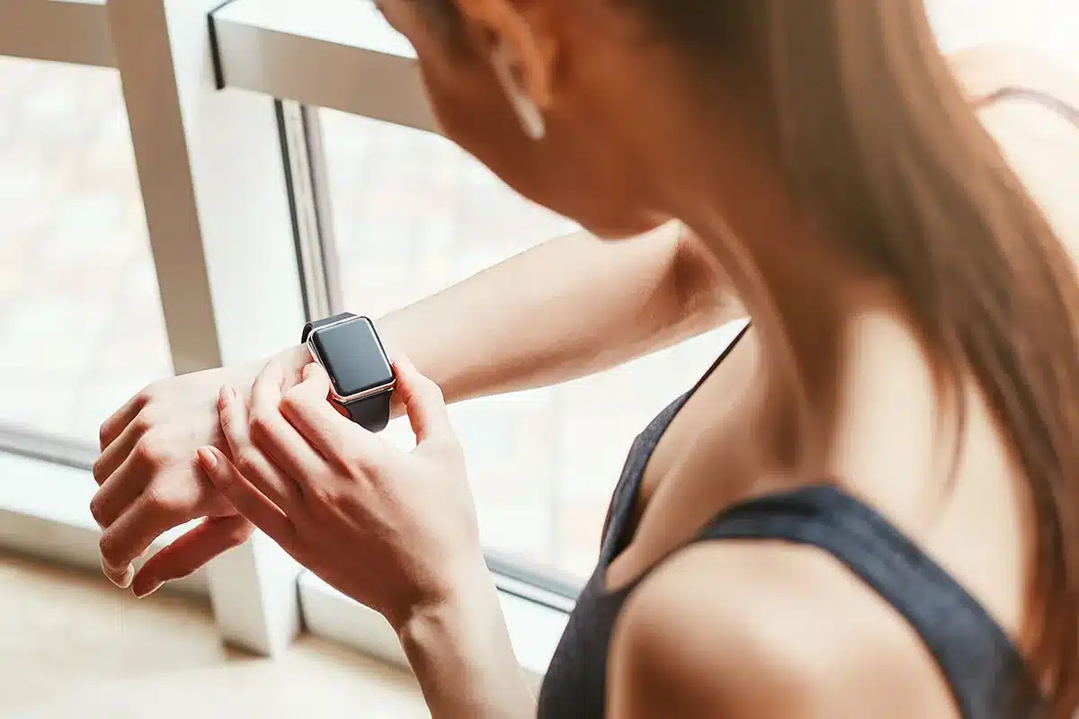 Woman checking fitness tracker.