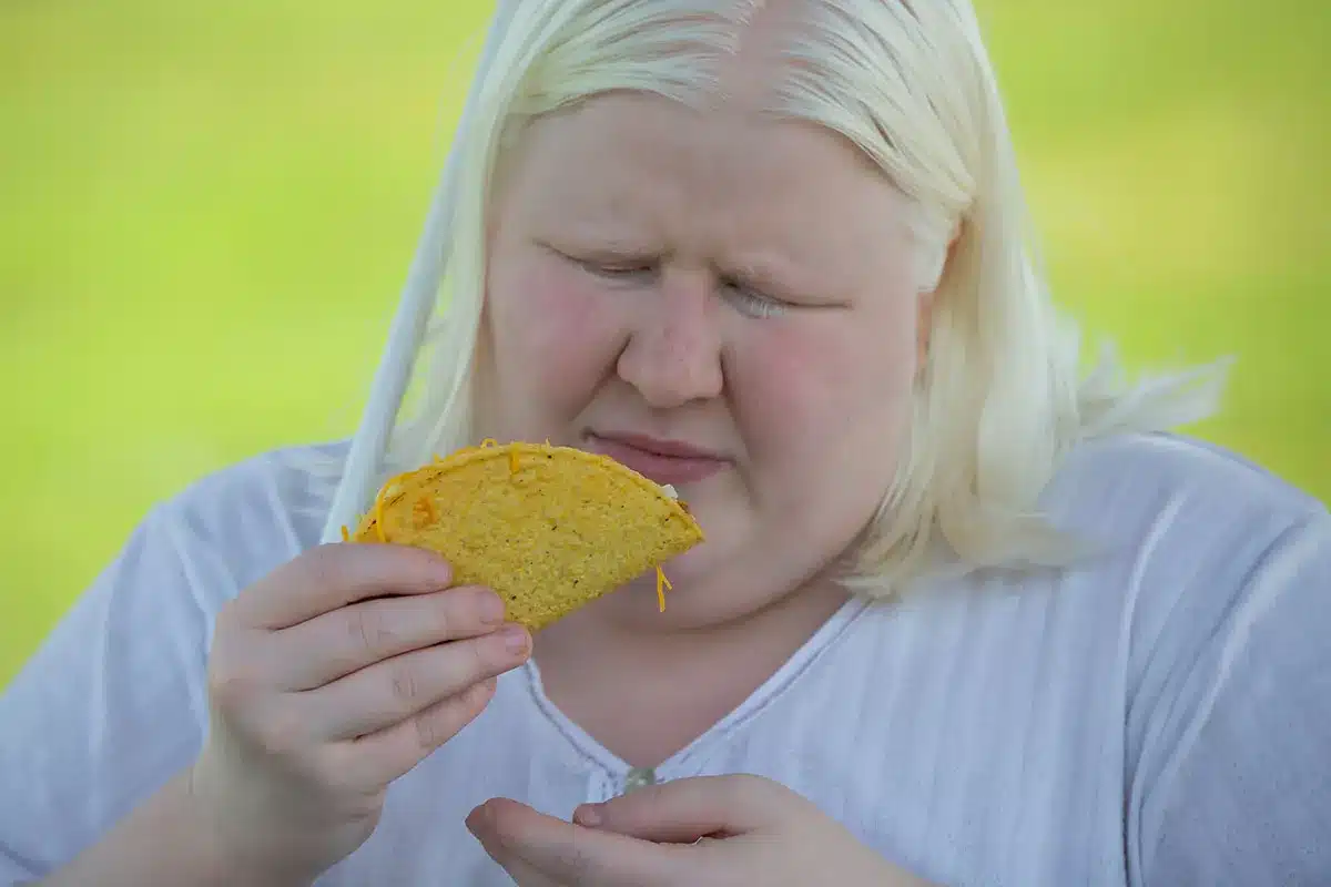 Plus-size woman enjoying a taco.