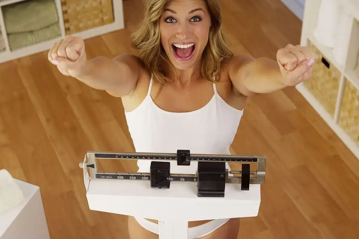Woman celebrating weight loss.
