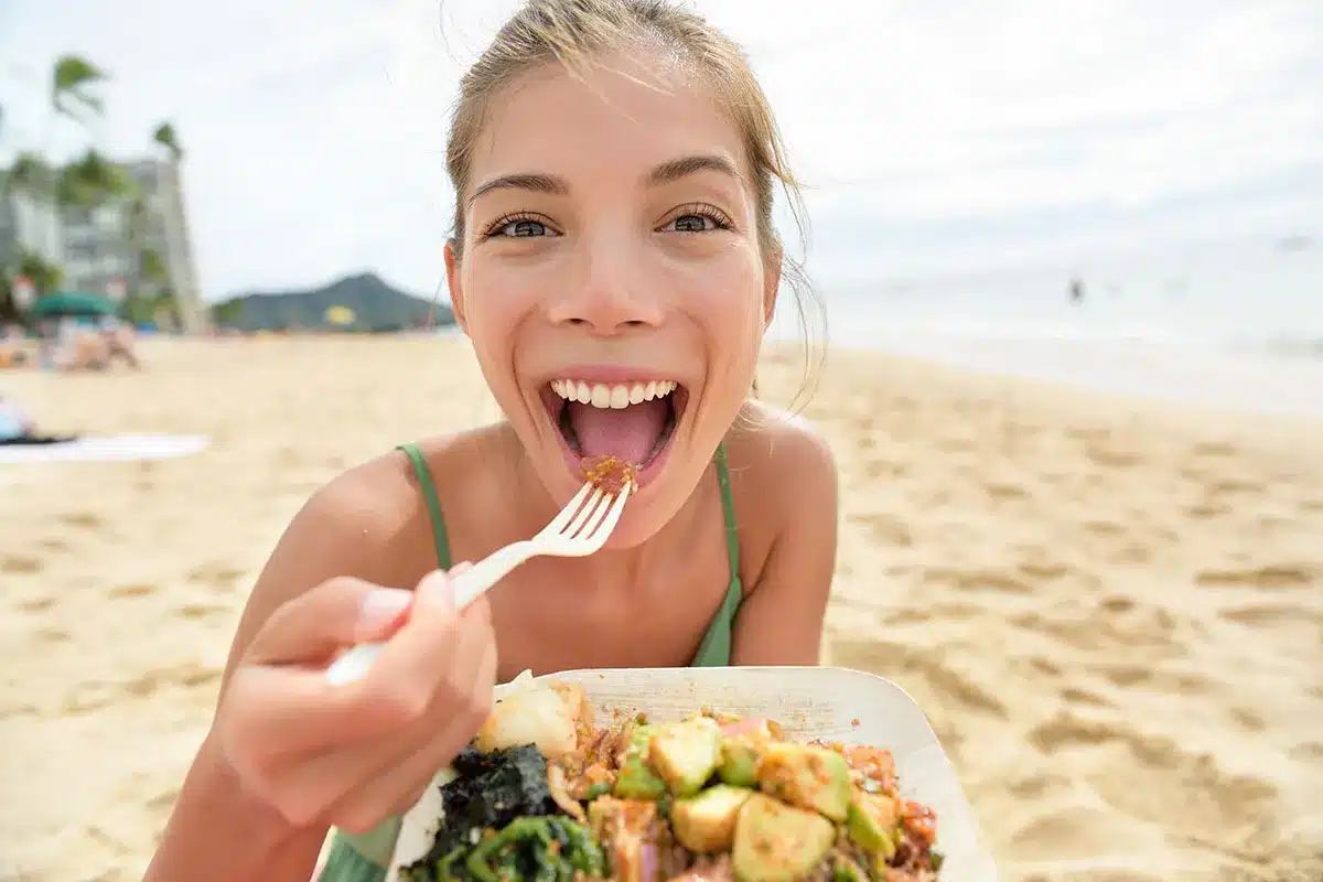 Woman enjoying beach meal.