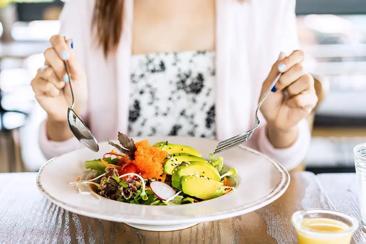 Woman eating a healthy salad.