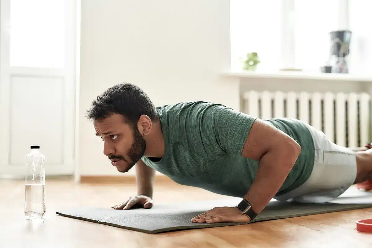 Man doing push-ups at home.