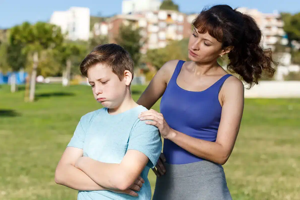Mother comforting upset child.