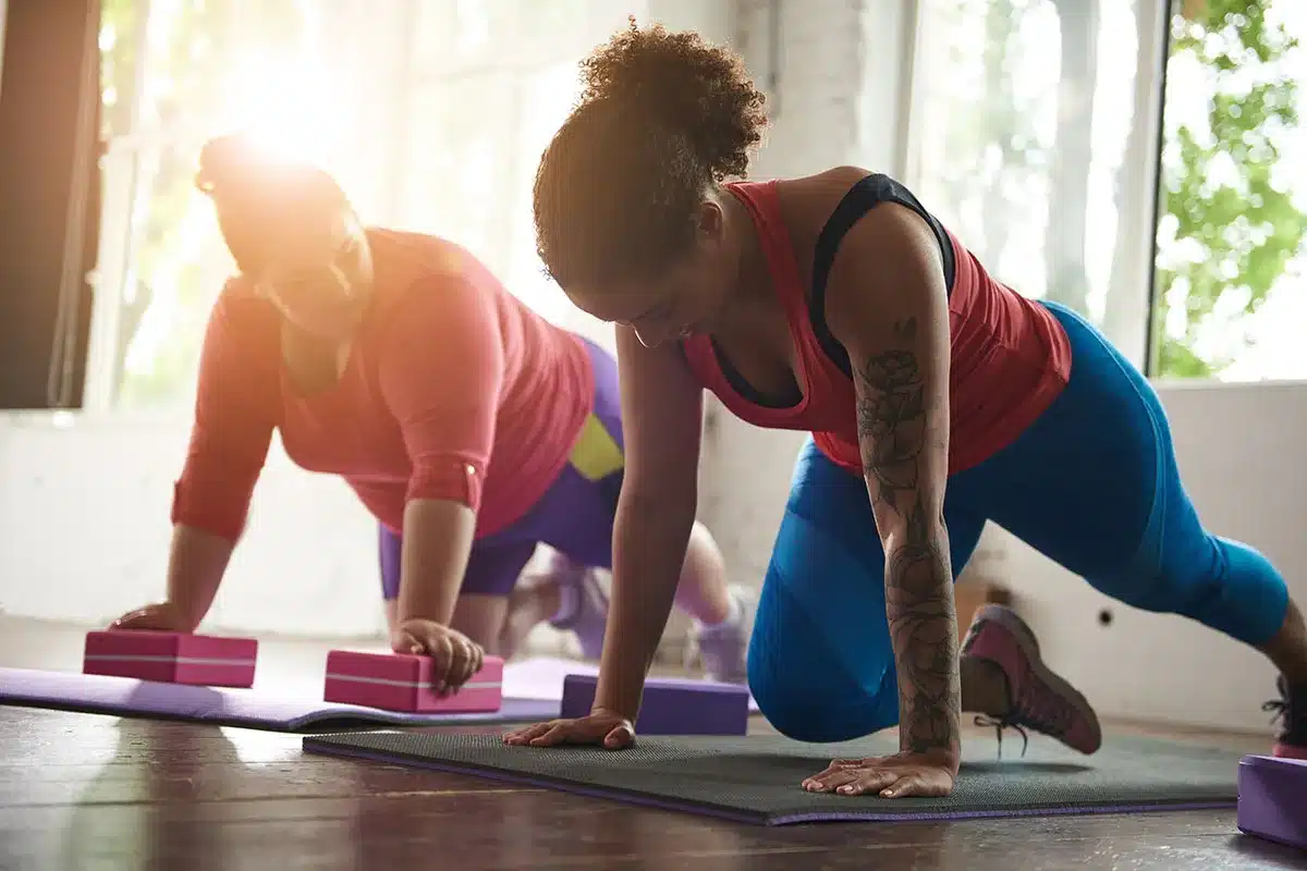 Two plus-size women doing a workout.