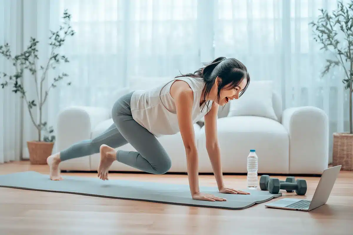 young asian woman doing sport exercises indoor
