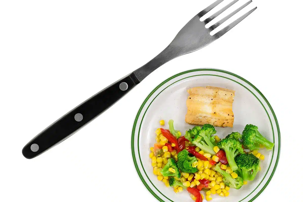 Plate of fish and vegetables.