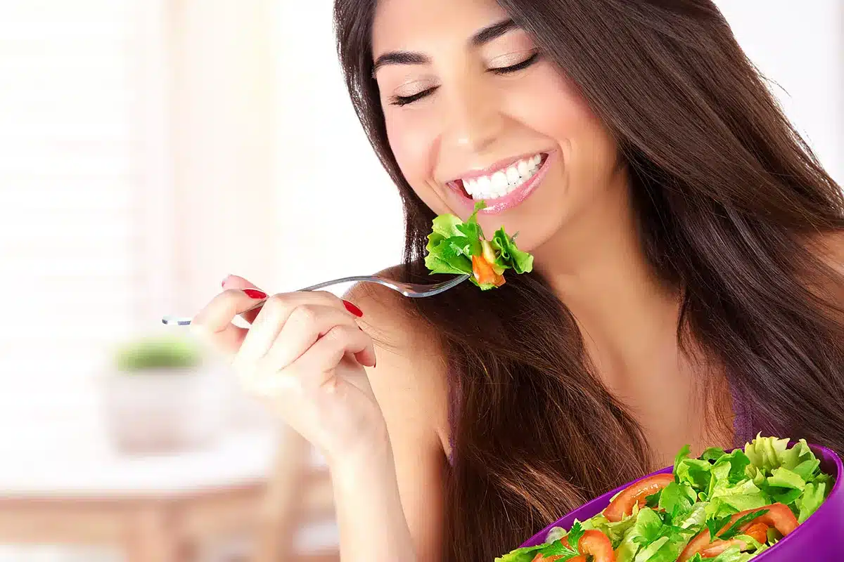Woman eating a healthy salad.
