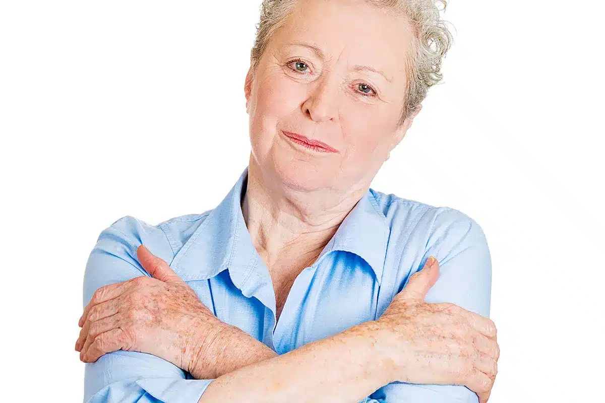 Senior woman with arms crossed.