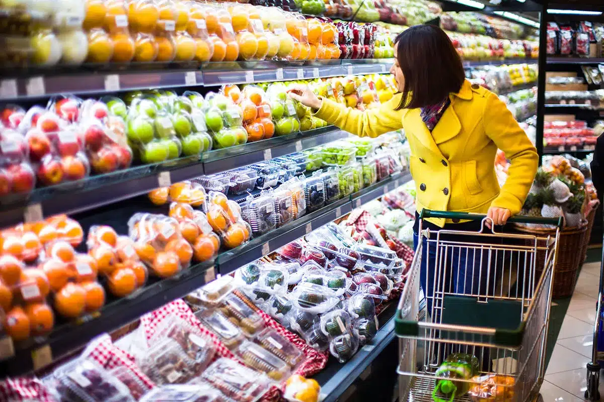 Woman shopping for fresh produce at grocery store.