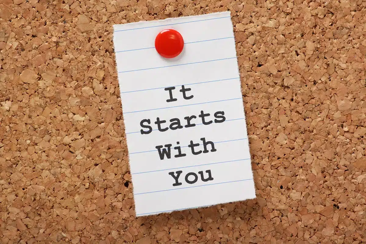 Note on corkboard: "It Starts With You".