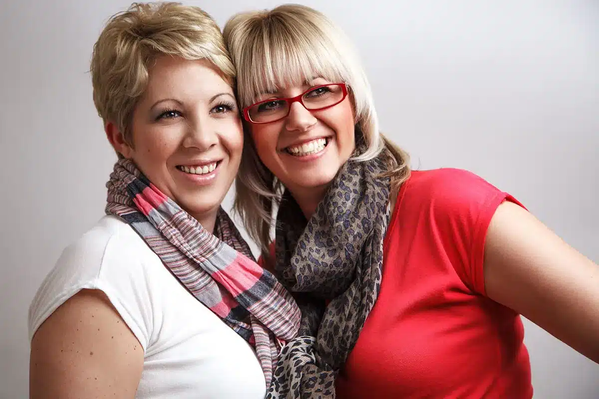 Two happy women smiling together.