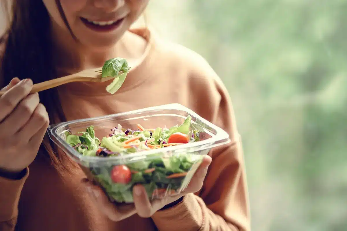 Woman eating a healthy salad.