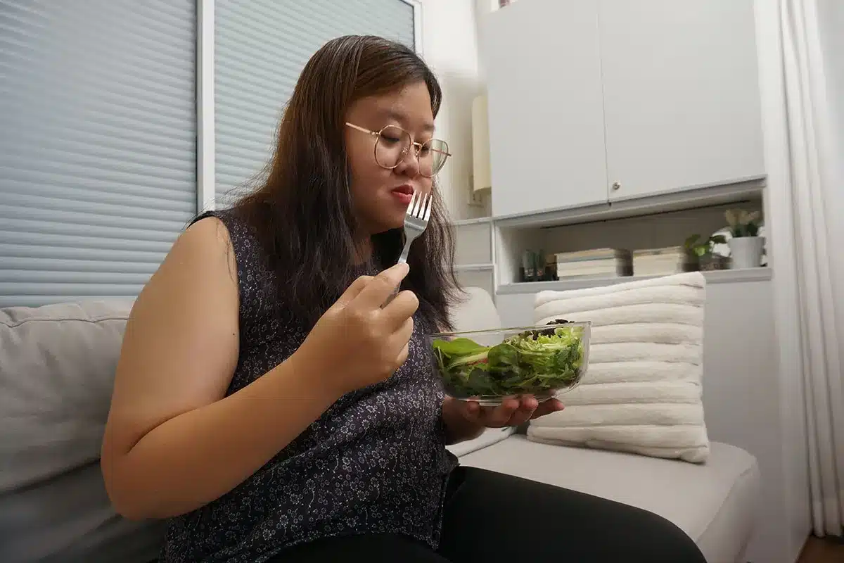 Woman eating healthy salad.