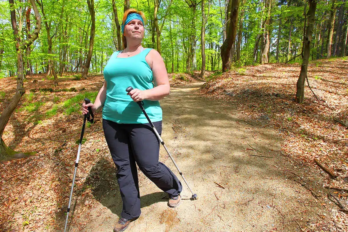 Plus-size woman hiking in the woods.