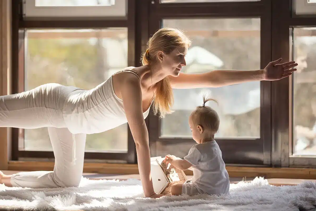Mother and baby doing yoga together.