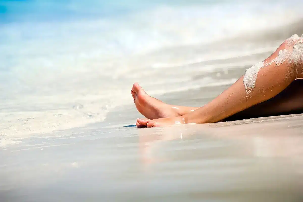Woman's feet on sandy beach.
