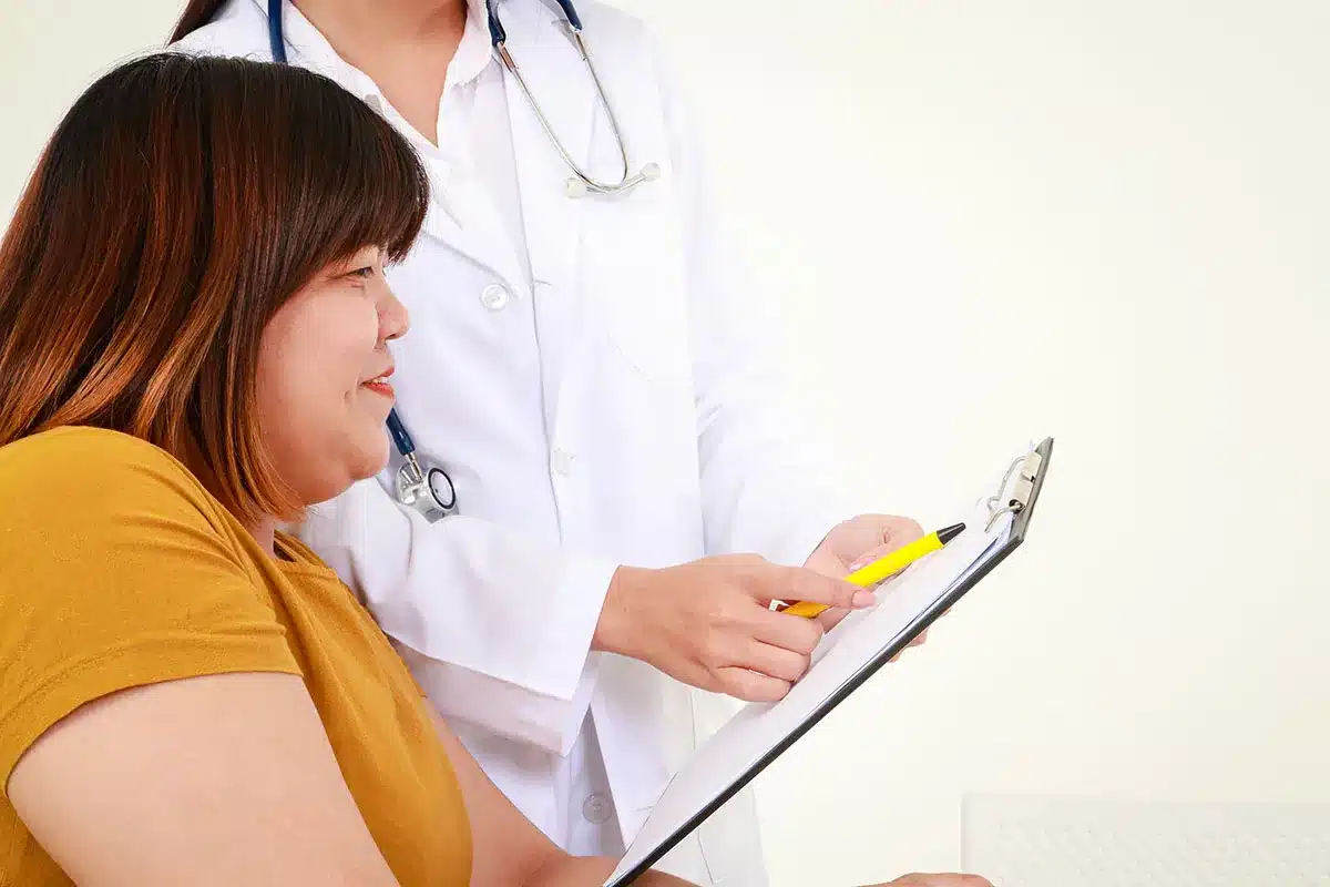 Doctor and patient reviewing medical chart.