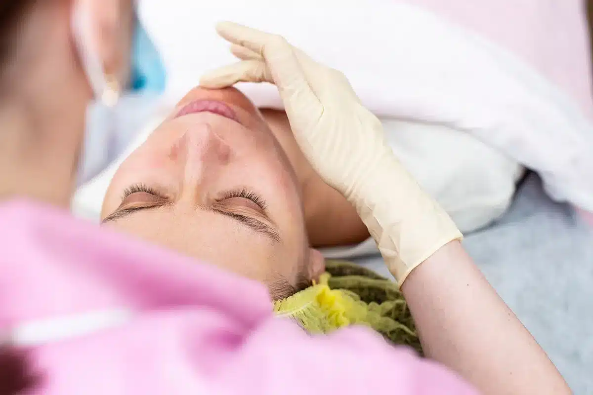 Woman receiving facial treatment.
