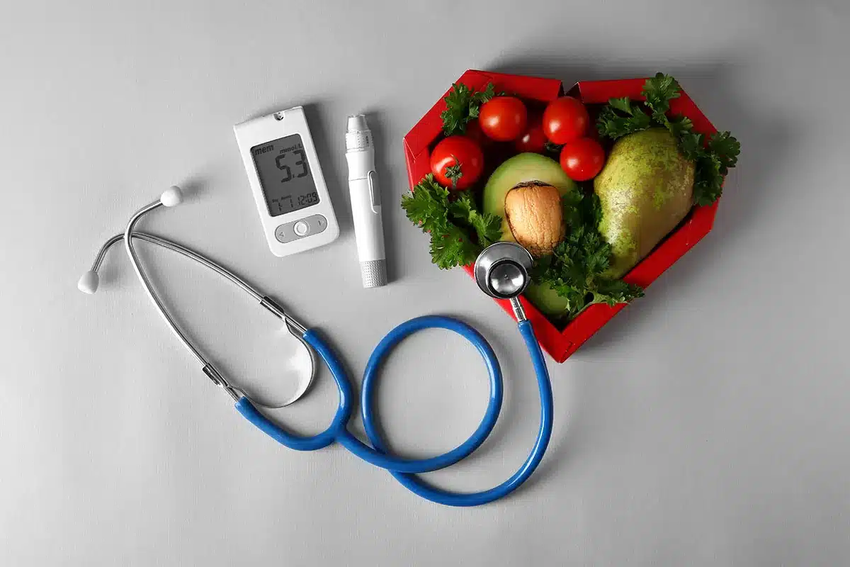 Heart-shaped arrangement of healthy foods and medical tools.