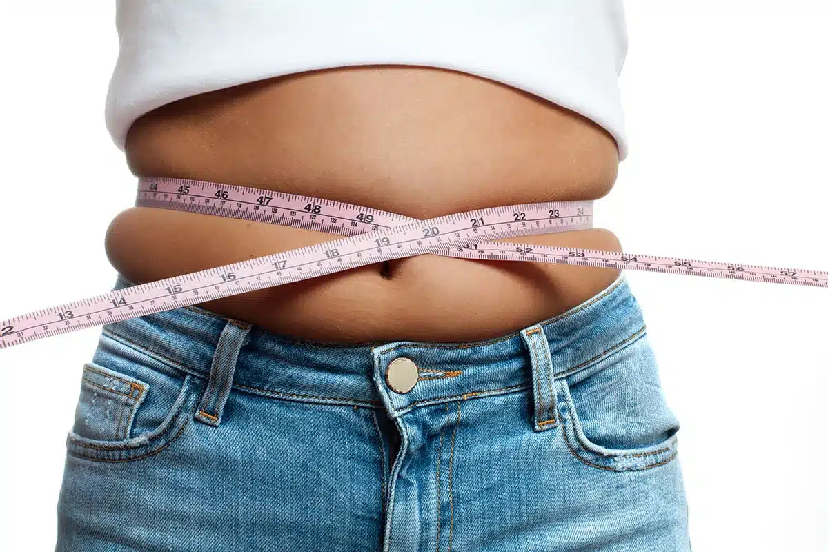 Measuring waist circumference with tape.