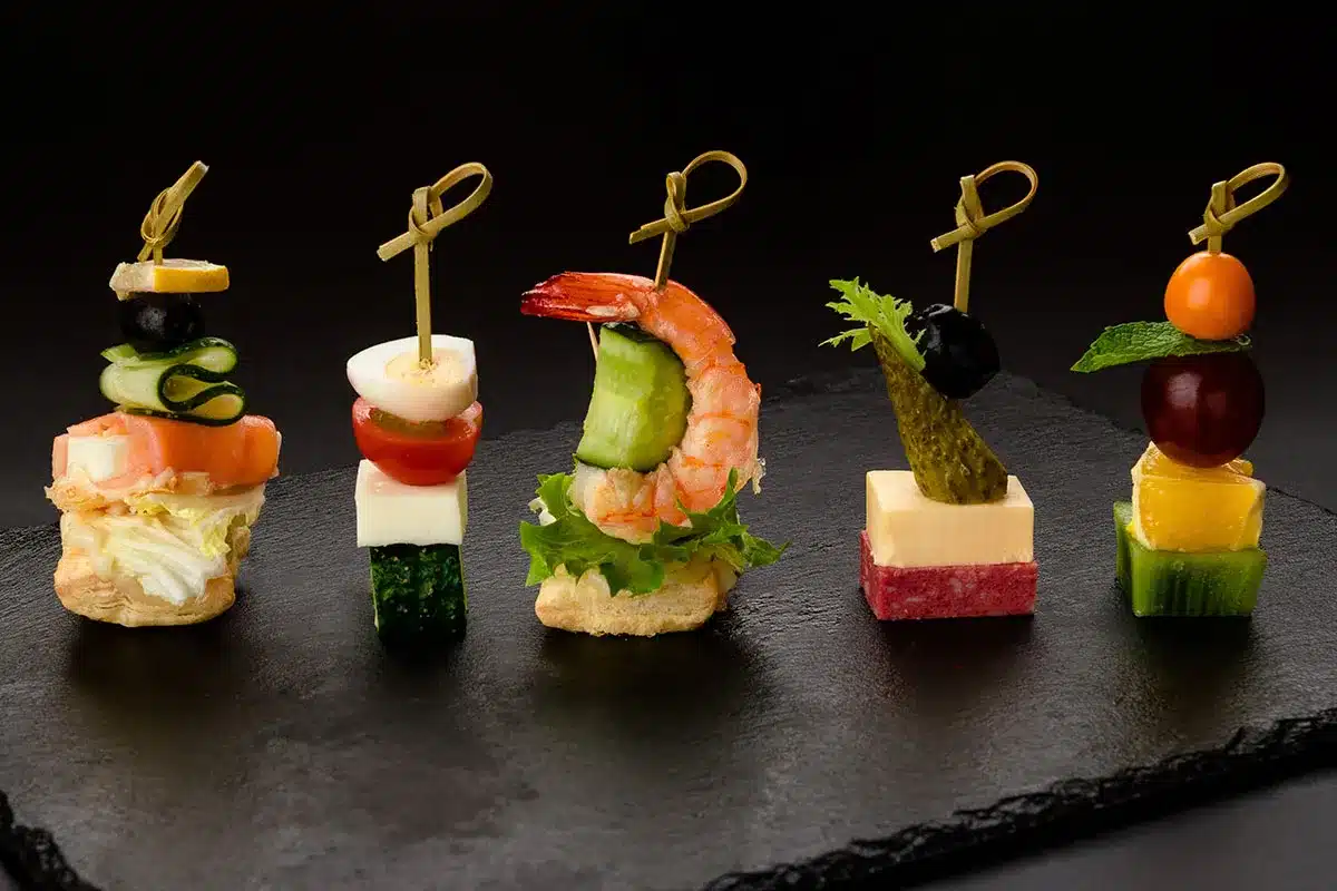 Assorted gourmet appetizer skewers.