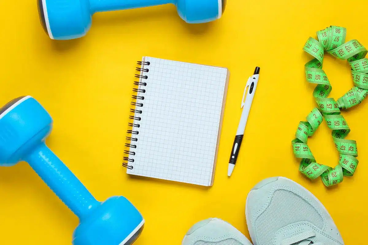 Dumbbells, notebook, pen, measuring tape, shoes.