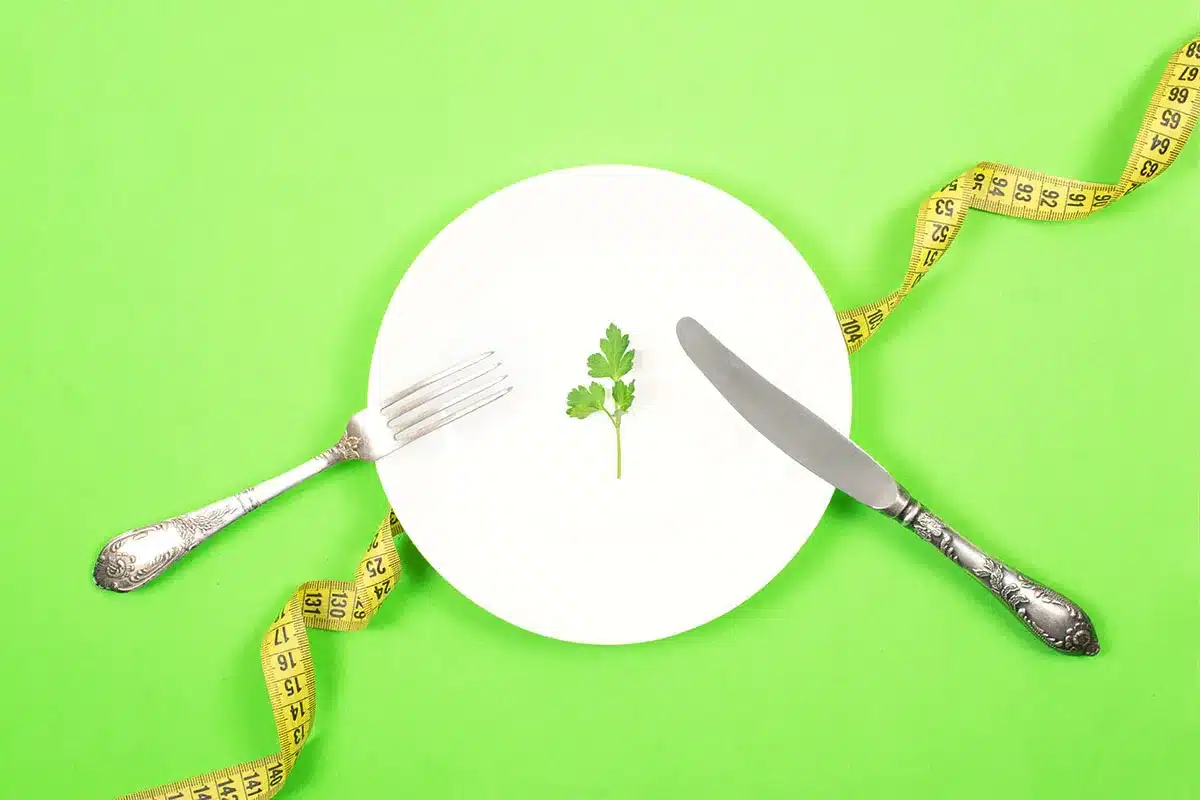 Empty plate, parsley sprig, measuring tape.