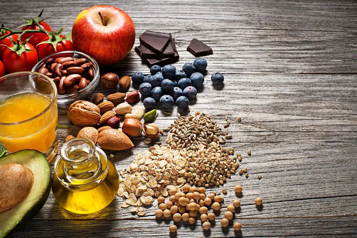 Variety of healthy foods on wooden background.