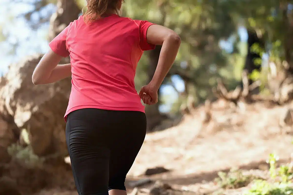Woman trail running in nature.