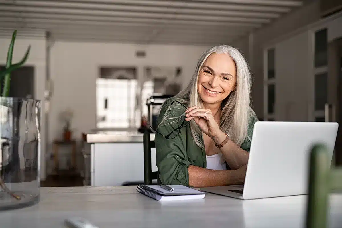 Smiling senior woman working from home.