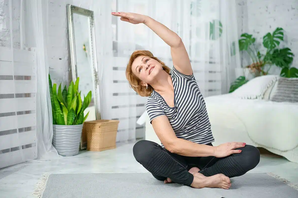 Senior woman stretching at home.