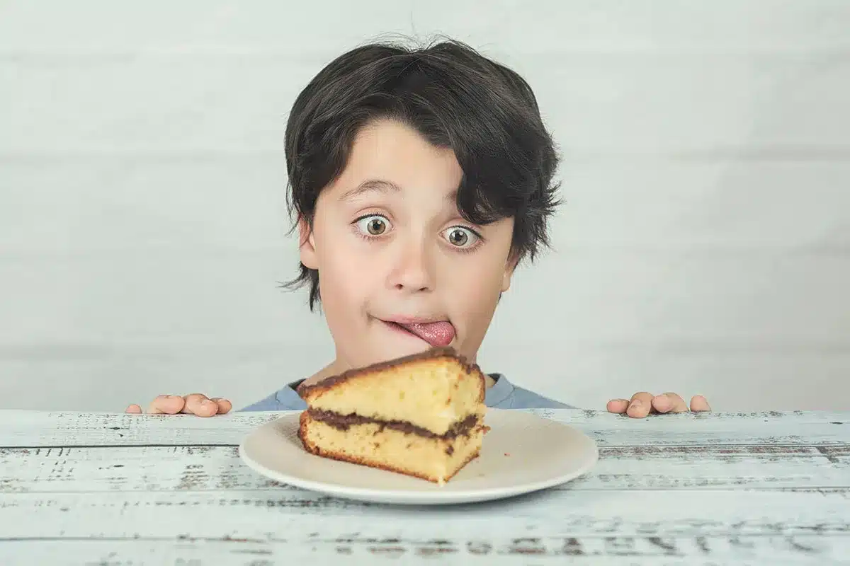 Boy with wide eyes looking at cake.