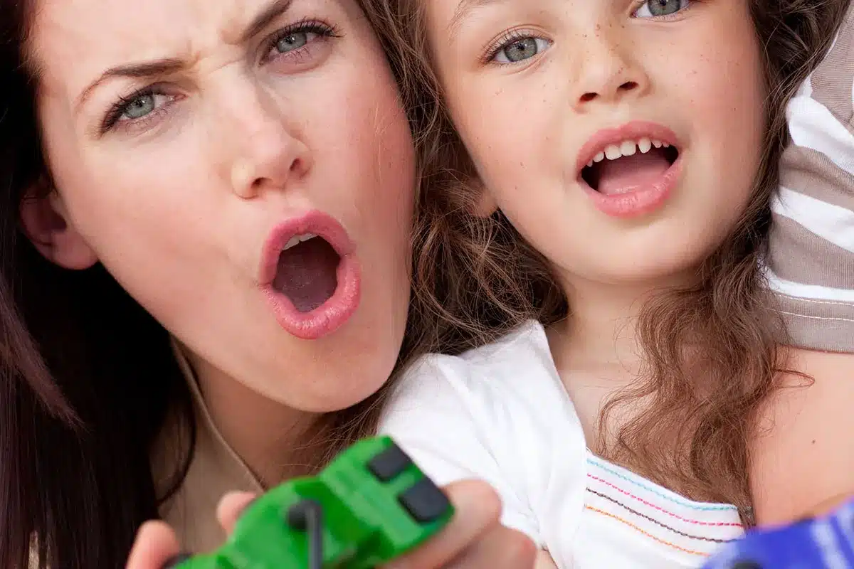 Mother and daughter playing video games.