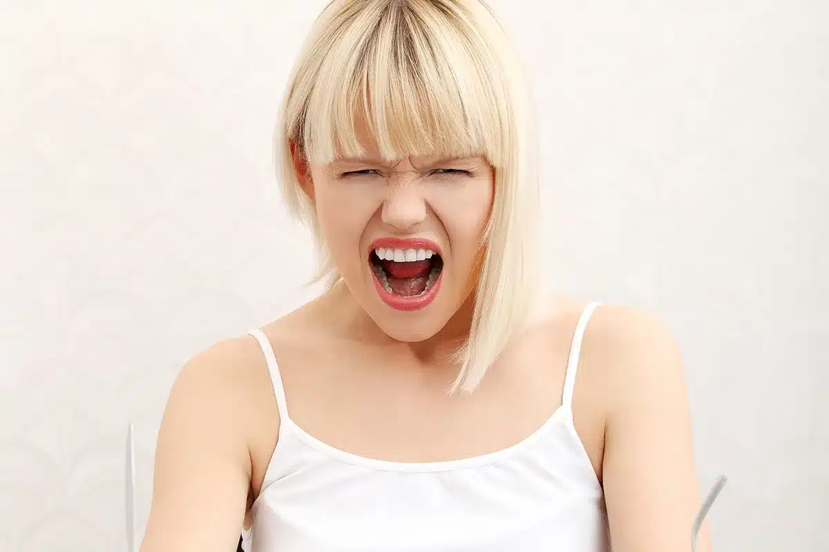 Angry young woman yelling.