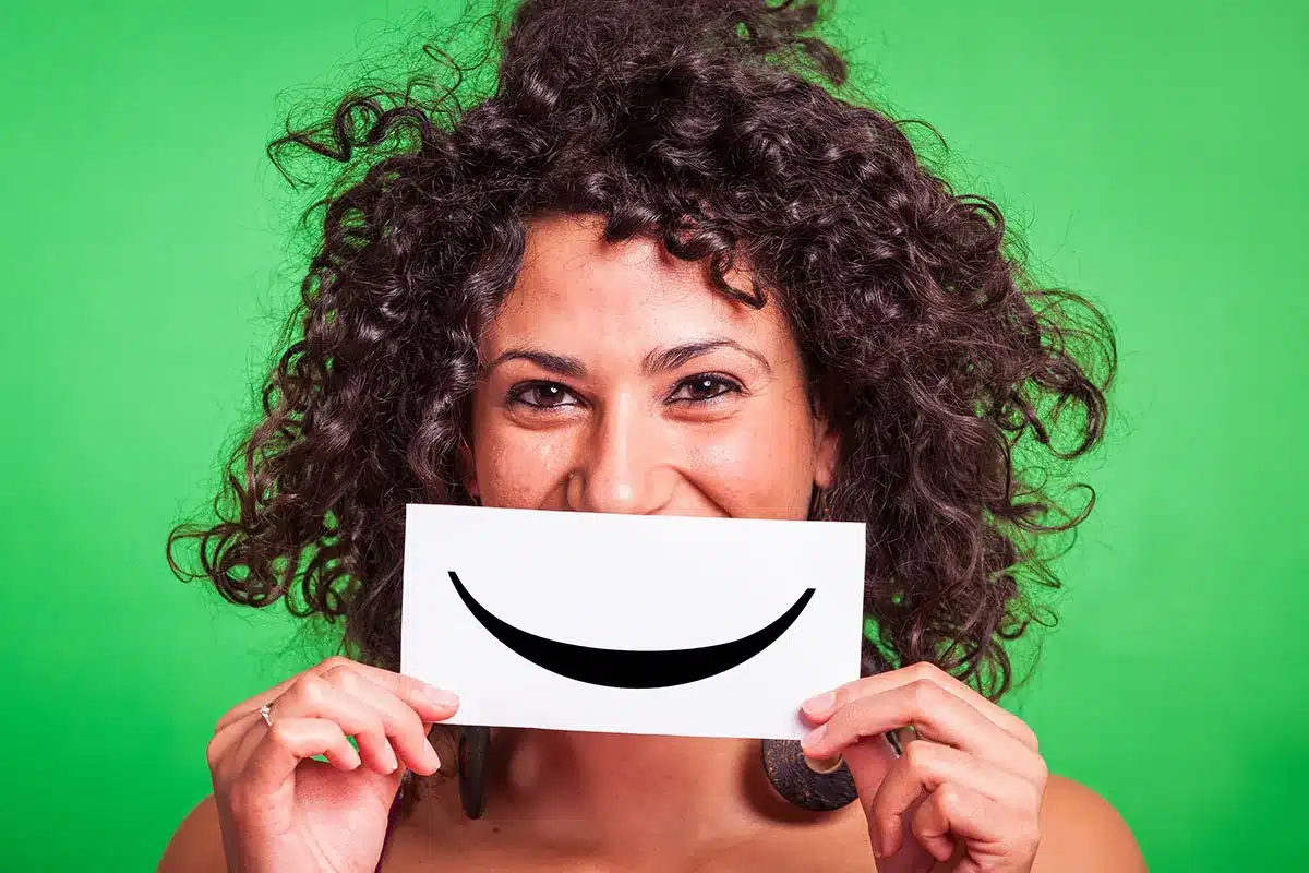 Woman holding a smile card.