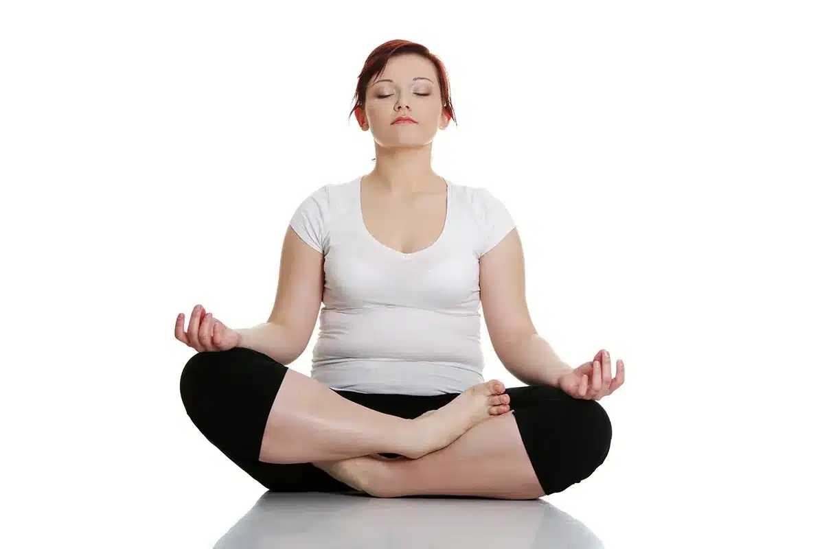 Woman meditating in lotus position.