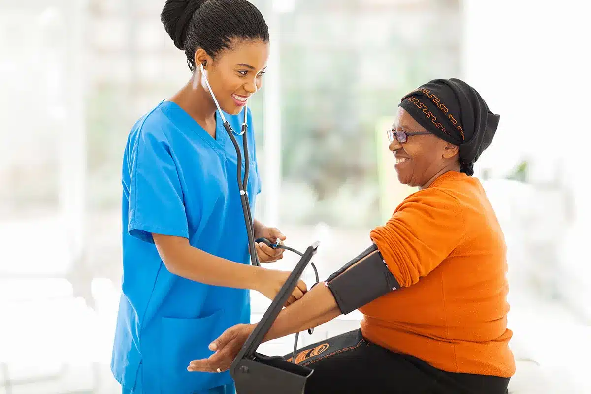 Nurse taking patient's blood pressure.