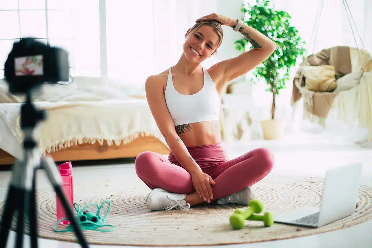 Fitness influencer recording workout video.