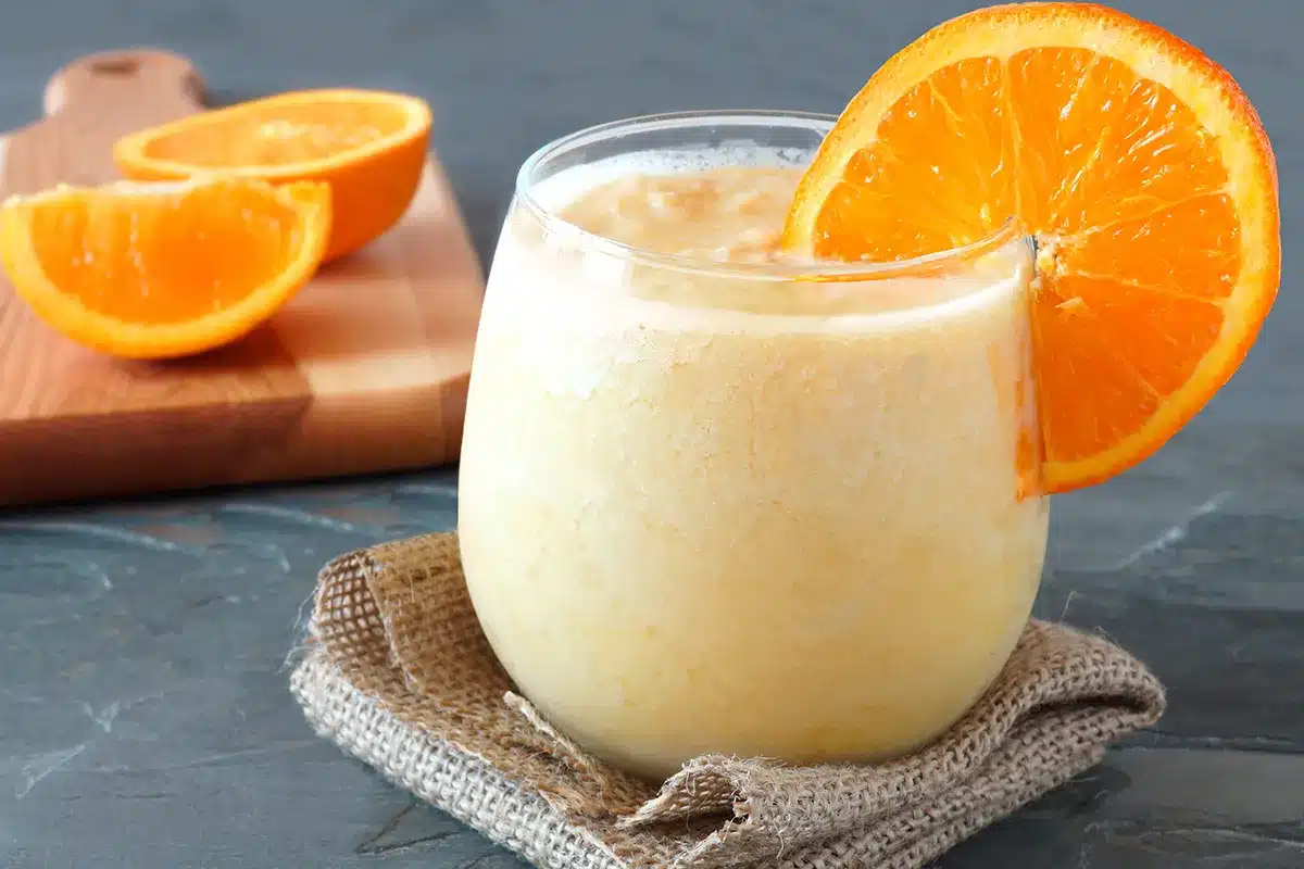 healthy orange fruit smoothie in a stemless glass